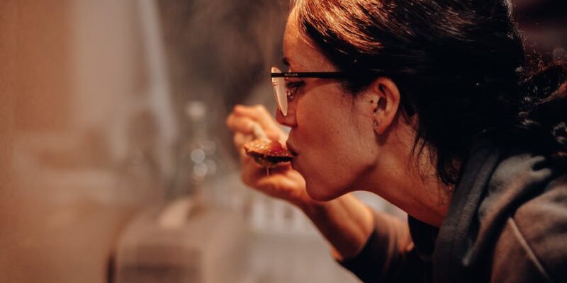 woman eating on cooking pan